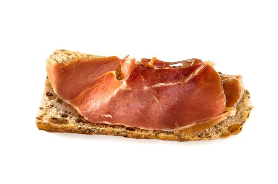 Slice of fresh homemade Alpine Baguette with jamon isolated over