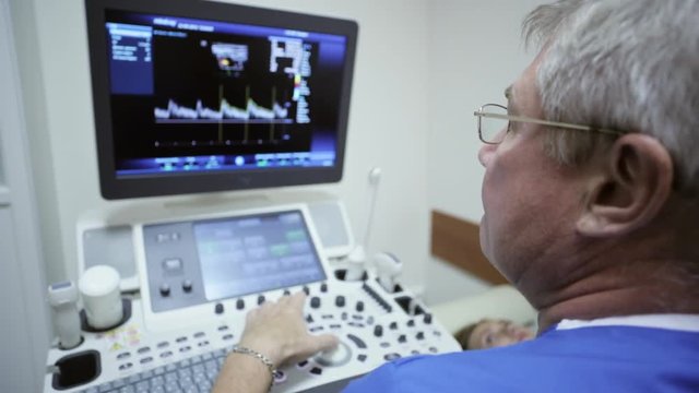 Doctor is using ultrasound machine to scan of a female patient