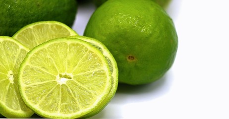 Lime or lemon with some slice on white plate