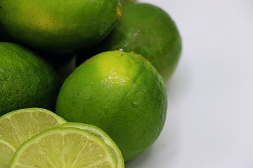 Lime or lemon with some slice on white plate