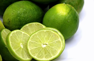 Lime or lemon with some slice on white plate