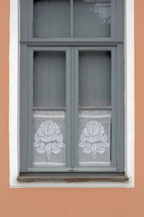 Window with crochet curtain with floral motif
