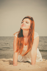 Red haired girl outdoor on beach