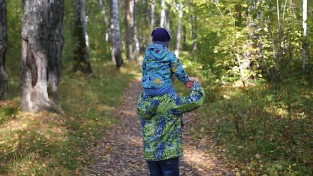 children run along the path in Park in autumn