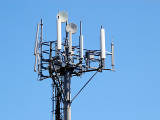 Telecommunications antenna on blue sky background