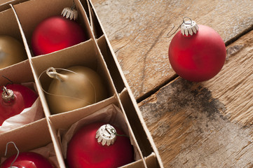 Red and gold Christmas baubles in a box