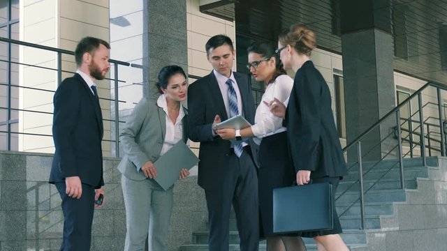 Group of ambitious business people discussing their plans before going to the meeting