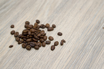 Spilled coffee beans on wood table