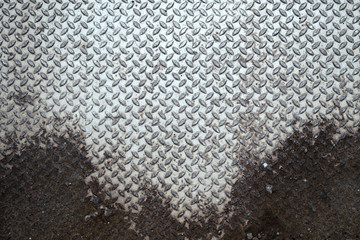 metal sheet diamond plate floor material with rust at bottom background - text space