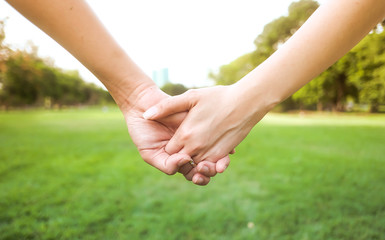 Happy couple holding hands in the sunset