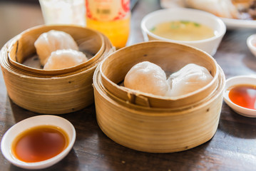 chinese steamed dimsum in bamboo containers  with soy sauce trad