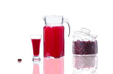 decanter and glass with cranberry juice and a jar with cranberri