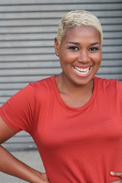 Pretty African American woman smiling and laughing out loud. LOL. LMAO 