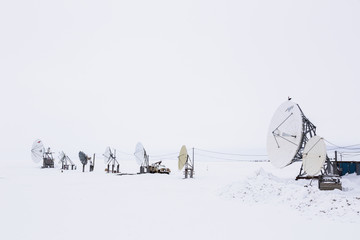 An array of satellite dishes pointing out to the ocean, Barrow, North Slope, Arctic Alaska, USA, Winter
