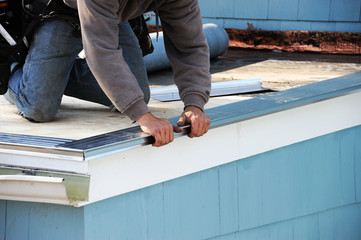 handyman working on repairing roof