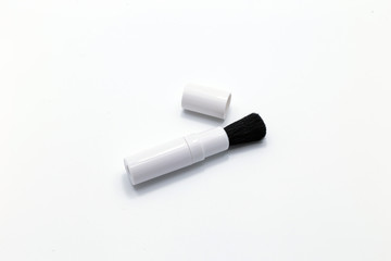 Brush for cleaning lens