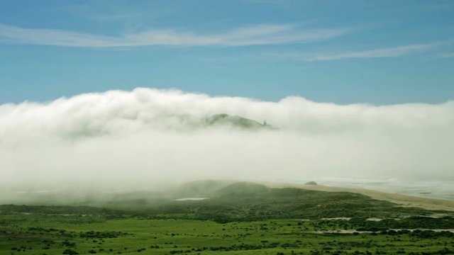 Low rolling clouds time lapse over coastal area in the morning.