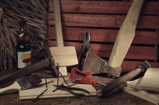 Retro stylized old tools on wooden table in a joinery.