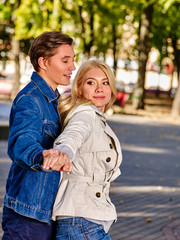 Fototapeta premium Young couple gay and girl dancing and flirting in autumn park . Love in autumn park.