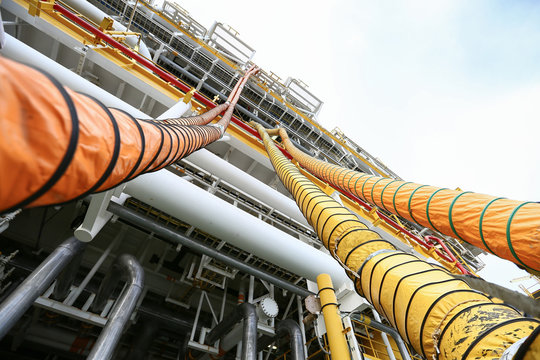 Hose line installed in oil and gas process and purge nitrogen gas into vessel for protected fire case, Offshore construction platform for production oil and gas, Oil and gas industry and hard work.
