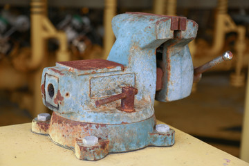 Vise tool in workshop or the garage for support hard work, Special tools for industry job, vise stand on the table with other basic tool, Hand tool on table for service and repair in industry job.