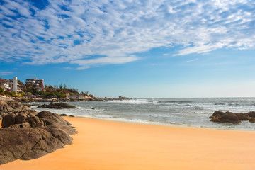 The view of the sandy shores on the beautiful skies and small ho