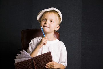 Boy with notebook and pen
