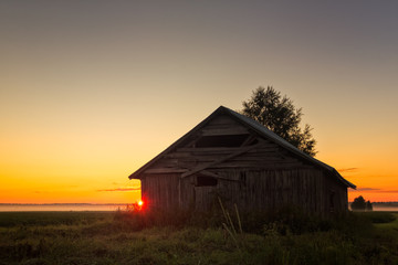 Summer Sunset Behind A Barn House