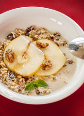 Oatmeal with pear and walnuts in the bowl