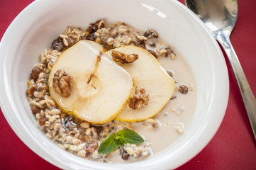 Oatmeal with pear and walnuts in the bowl