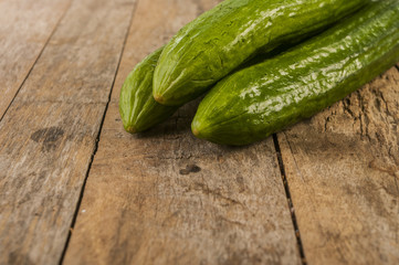 Cucumbers on a wooden background.