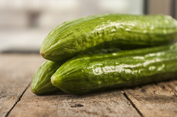 Cucumbers on a wooden background.