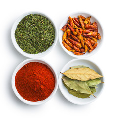 Various dried herbs and spices in bowl.