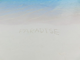 Inscription on the sand Paradise