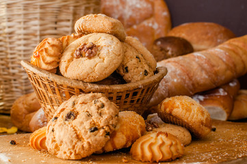 Freshly baked cookies and sweet pastries in the basket on wooden table