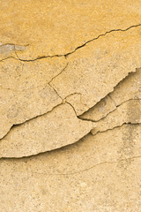Yellow stone surface with a crack