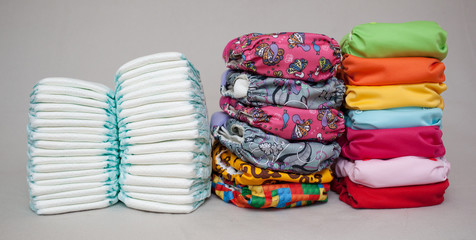 Stacks of disposable diapers and modern cloth diapers - obrazy, fototapety, plakaty