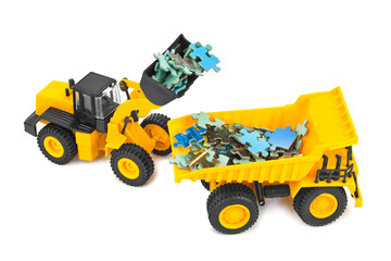 Obraz premium Toy loader and truck with puzzle