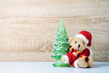 Christmas decoration Teddy Bear and christmas tree on wooden bac
