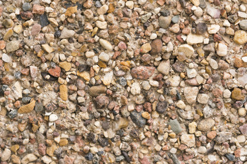 Brown stone wall of pebbles, background, texture
