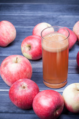 freshly squeezed apple juice in a glass on dark wooden table