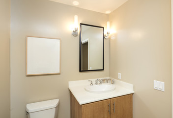 Bathroom interior in beige and wood cabinets and mirror and copy