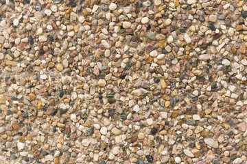 Brown stone wall of pebbles, background, texture