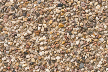 Brown stone wall of pebbles, background, texture