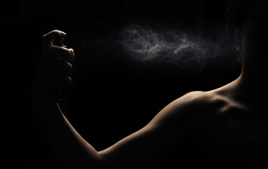 Spraying perfume in woman hand