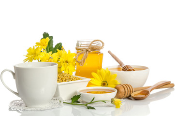 A cup of tea and bee products (honey, pollen) isolated on white