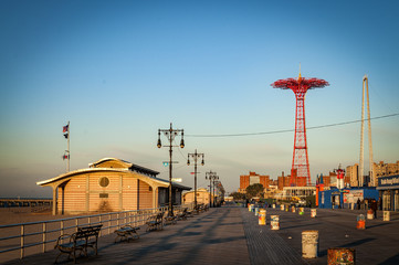 Deserted boardwalk in early morning silhouette of an empty Coney Island, Brooklyn, NYC, USA