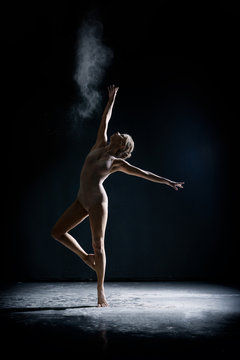 Image of artistic girl dancing with dust in studio