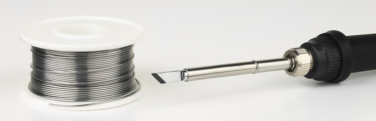 Soldering iron and  solder wire on  white background.