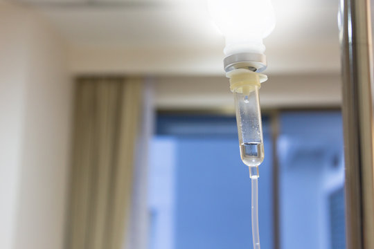 Close up saline solution drip for patient and infusion pump in h